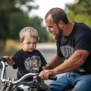 A man teaching his son to ride a motorcycle