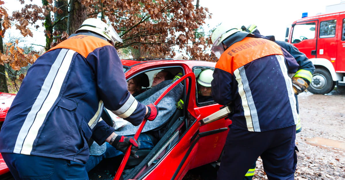 Rescuers helping car victims.