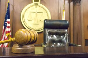 Inside the courtroom with gavel near judge's chair.