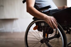 Disabled man with partial analysis with his wheelchair.