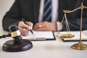 Lawyer writing case details in his desk.