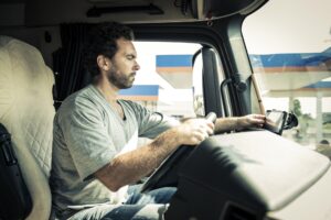 Truck driver using tablet while driving.