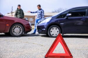 Two men talking car crash for their insurance claims.