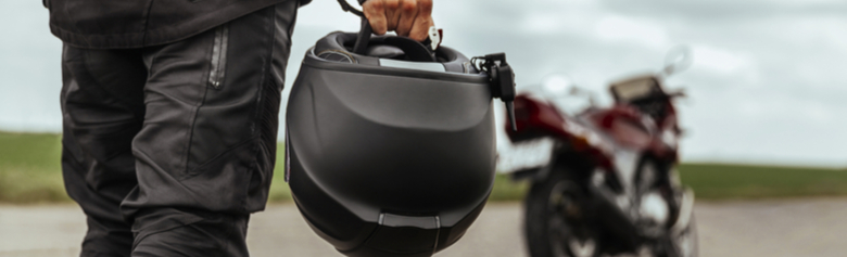 biker holding motorcycle helmet