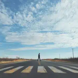 A pedestrian near a zebra crossing