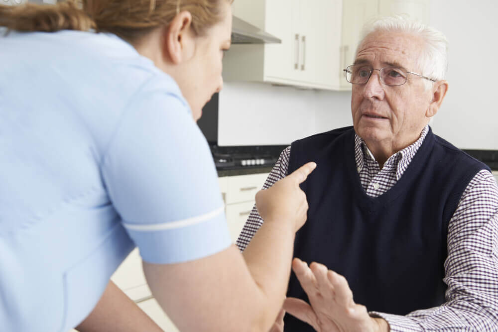 Male senior feeling scared by the nursing home attendant.