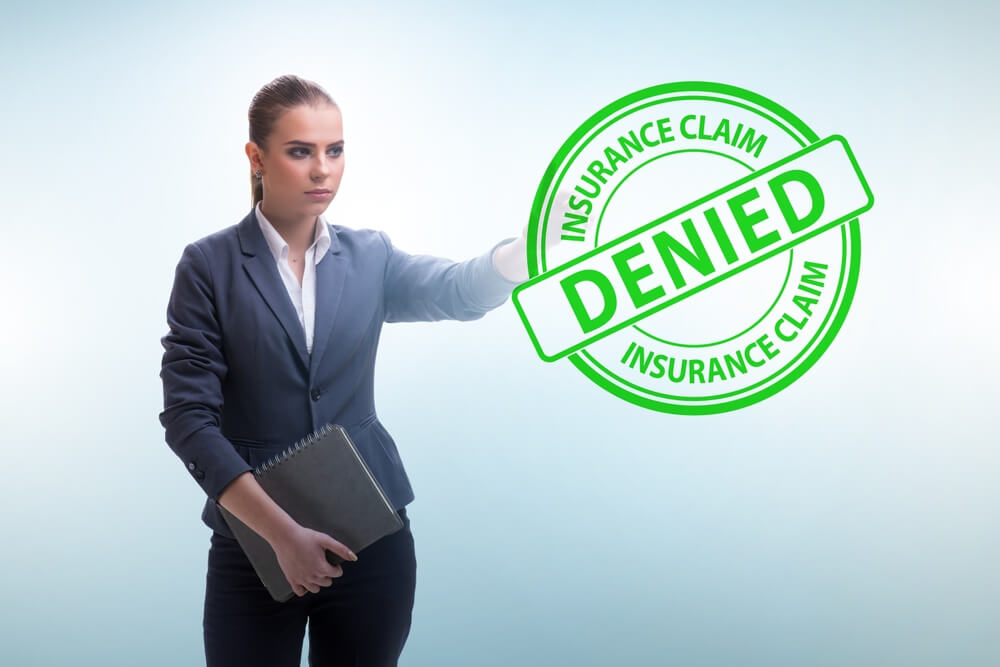 Agent showing insurance claim denied logo.