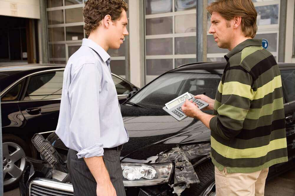 Driver involved in car crash talking to his insurance.